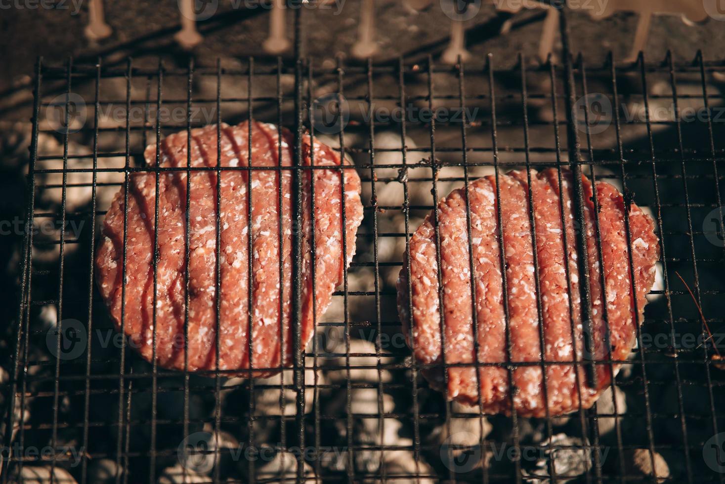 Fresh meat cutlets in a frying grill. photo