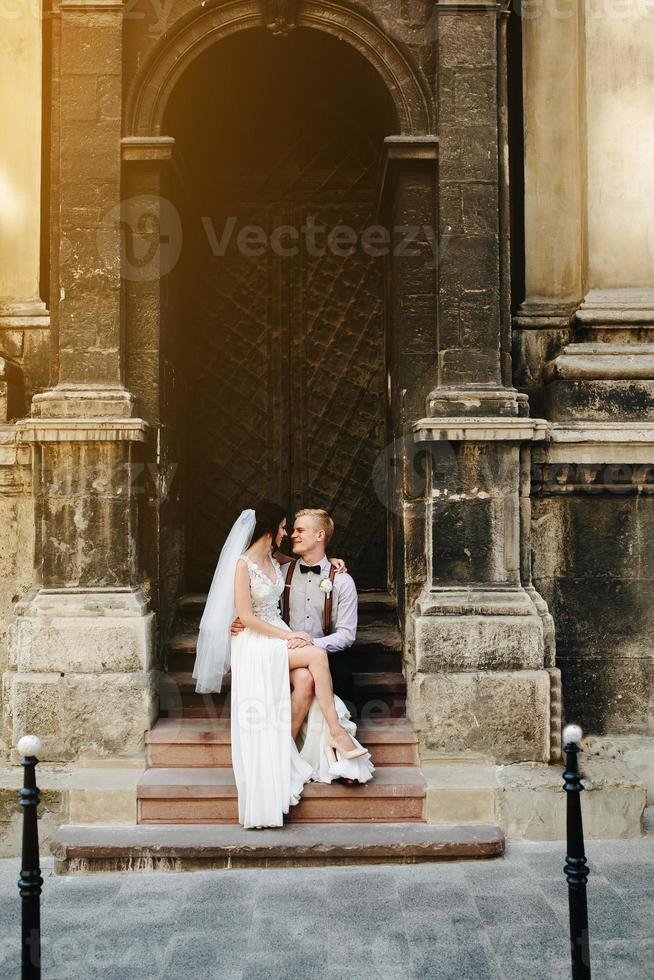 Bride sitting on lap of the bride photo