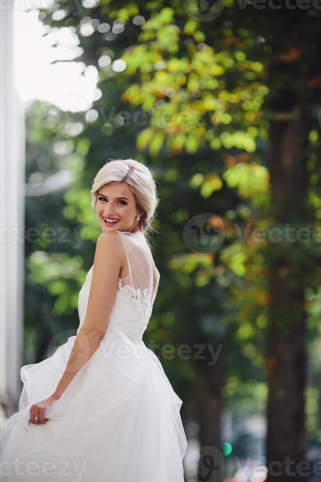 Young beautiful bride posing outdoors photo