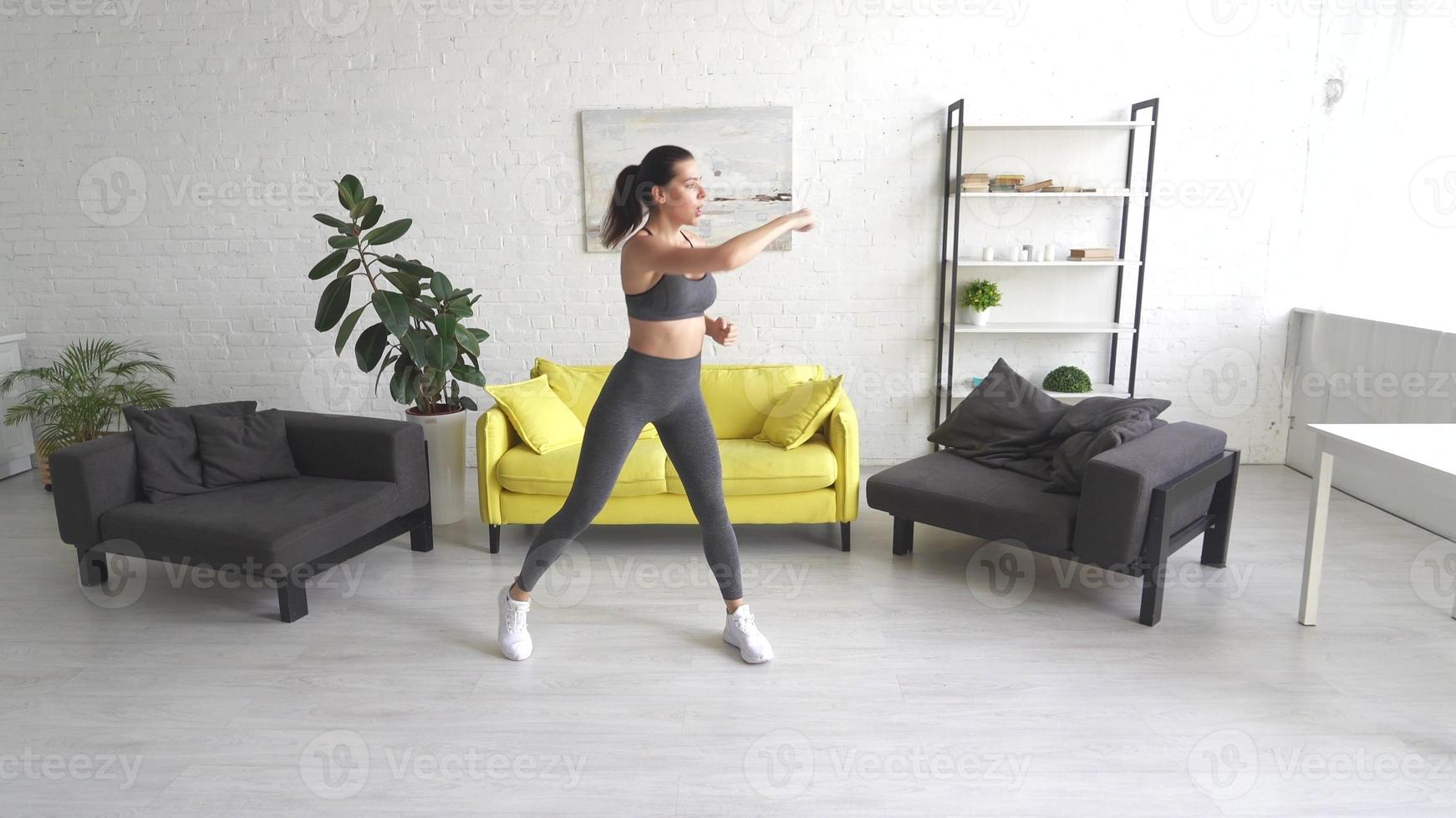 Beautiful young woman woman doing abdominal exercises in room photo