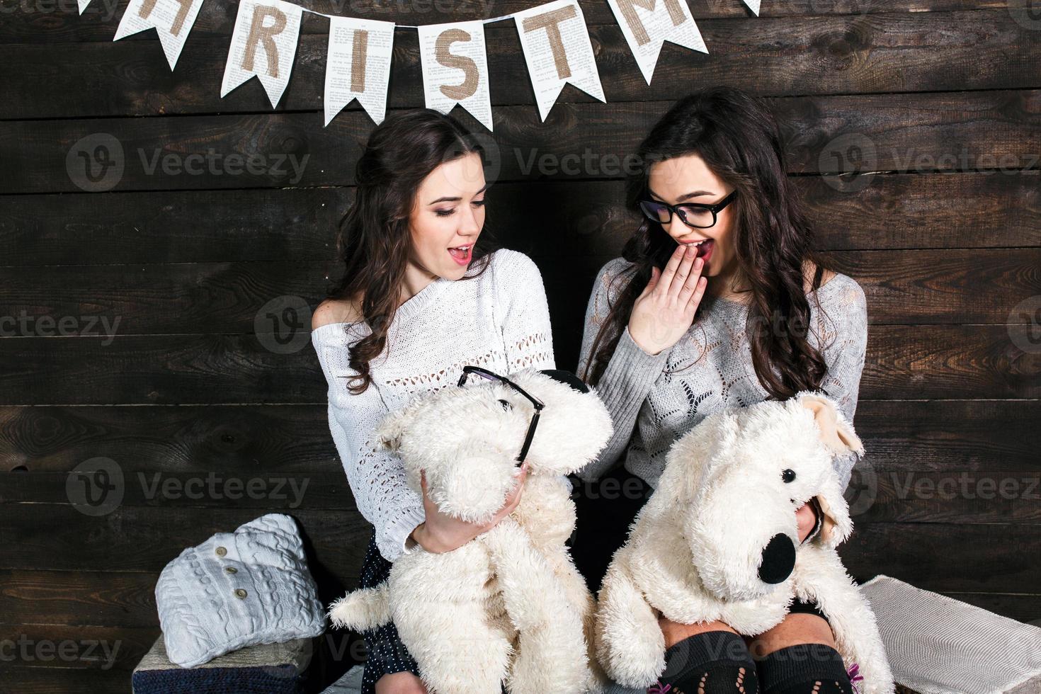 Two charming girls playing with Christmas toys photo