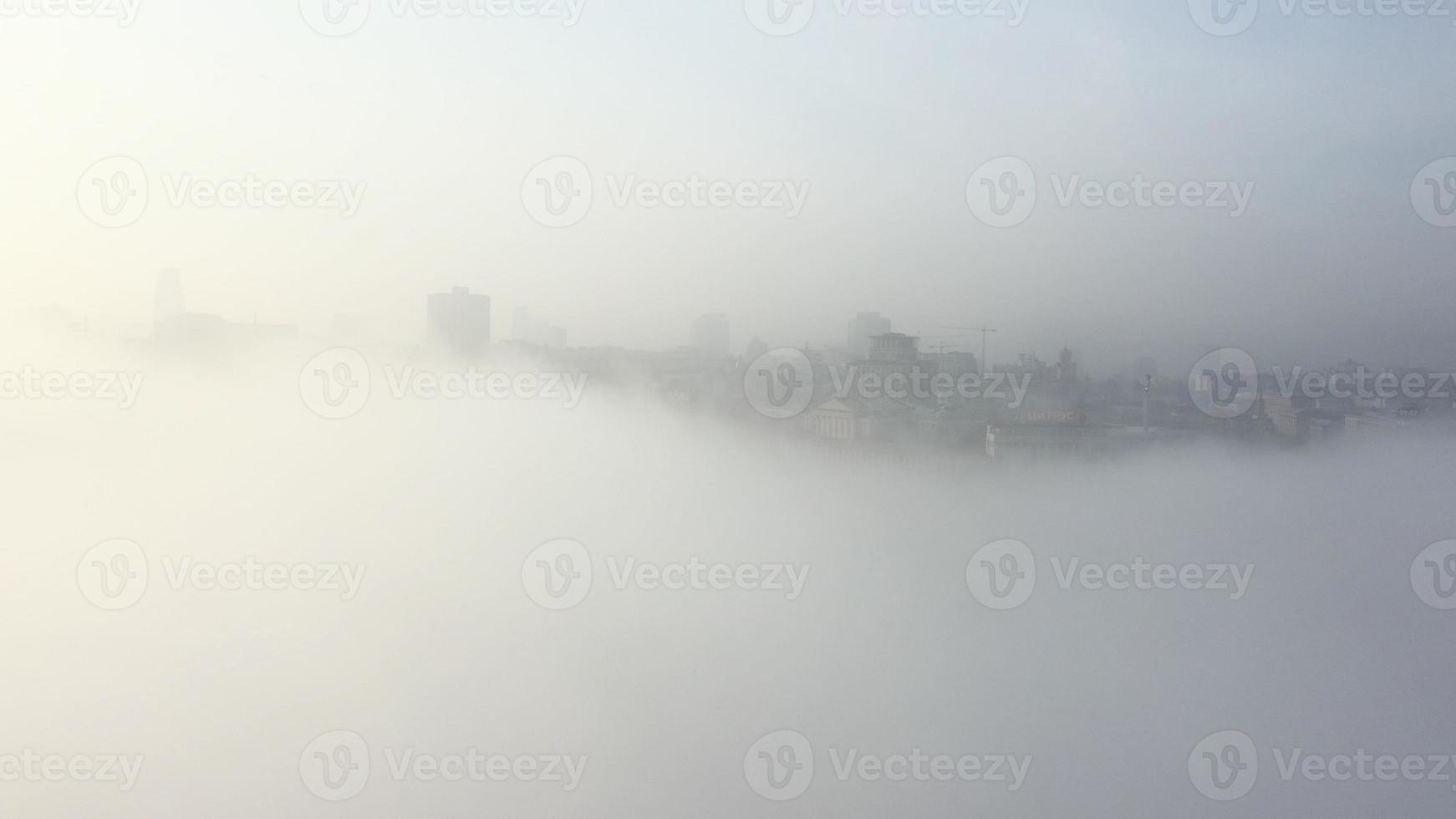 Aerial view of the city in the fog. photo