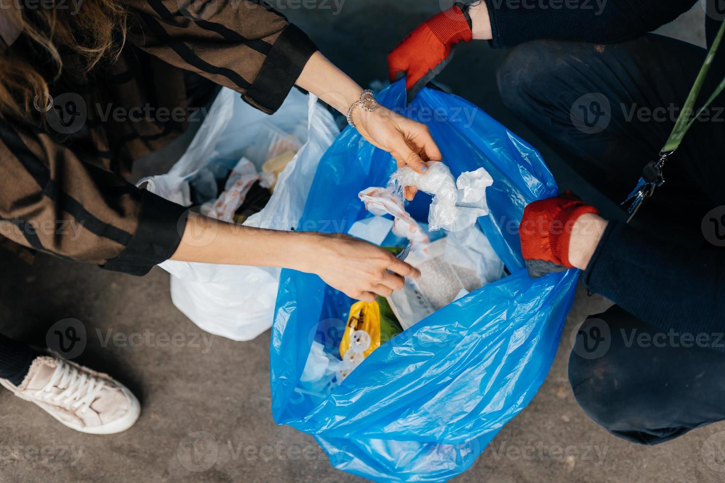 Two perrson sorting garbage. Concept of recycling. Zero waste photo
