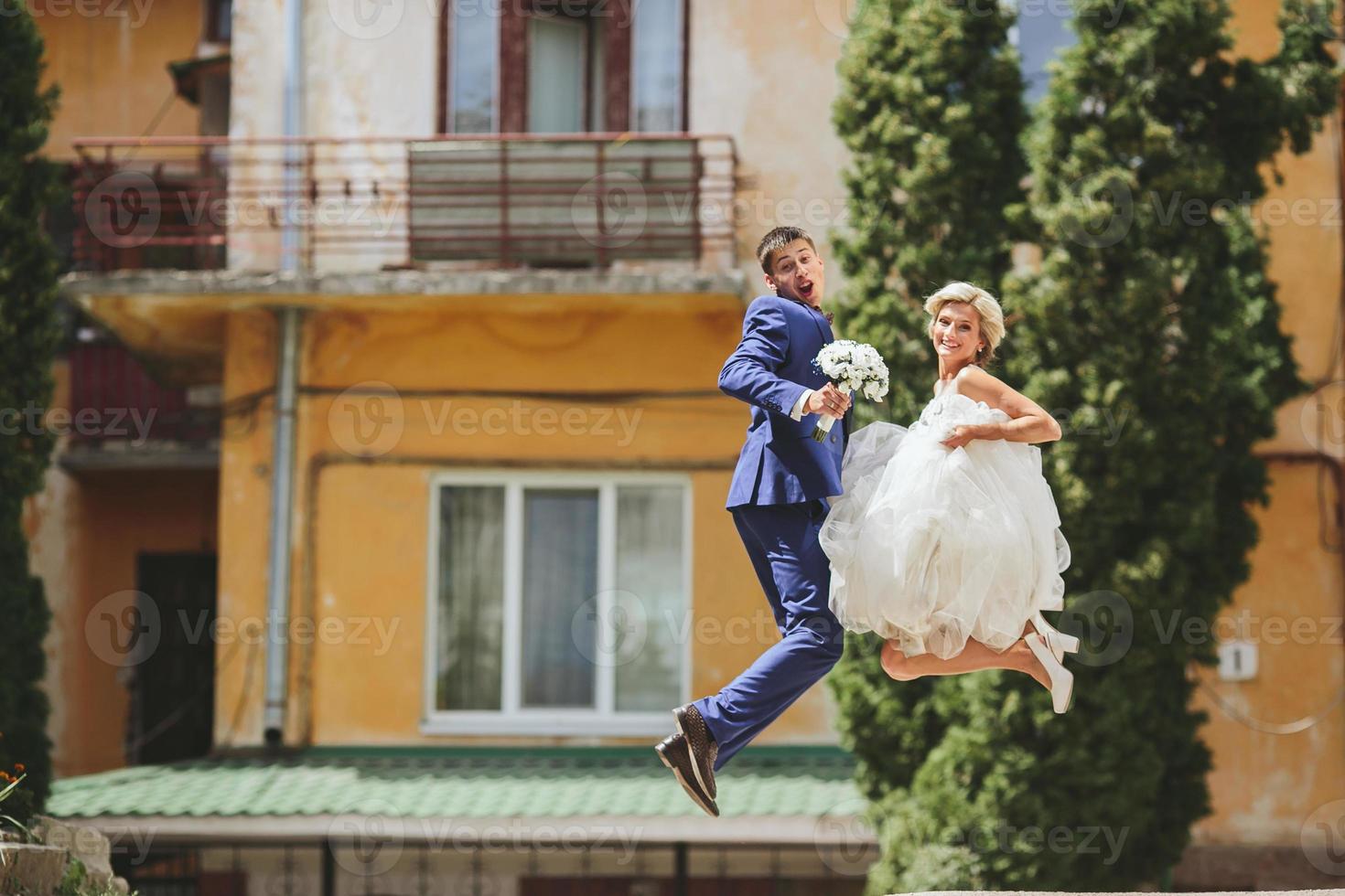 couple jumping on the street photo