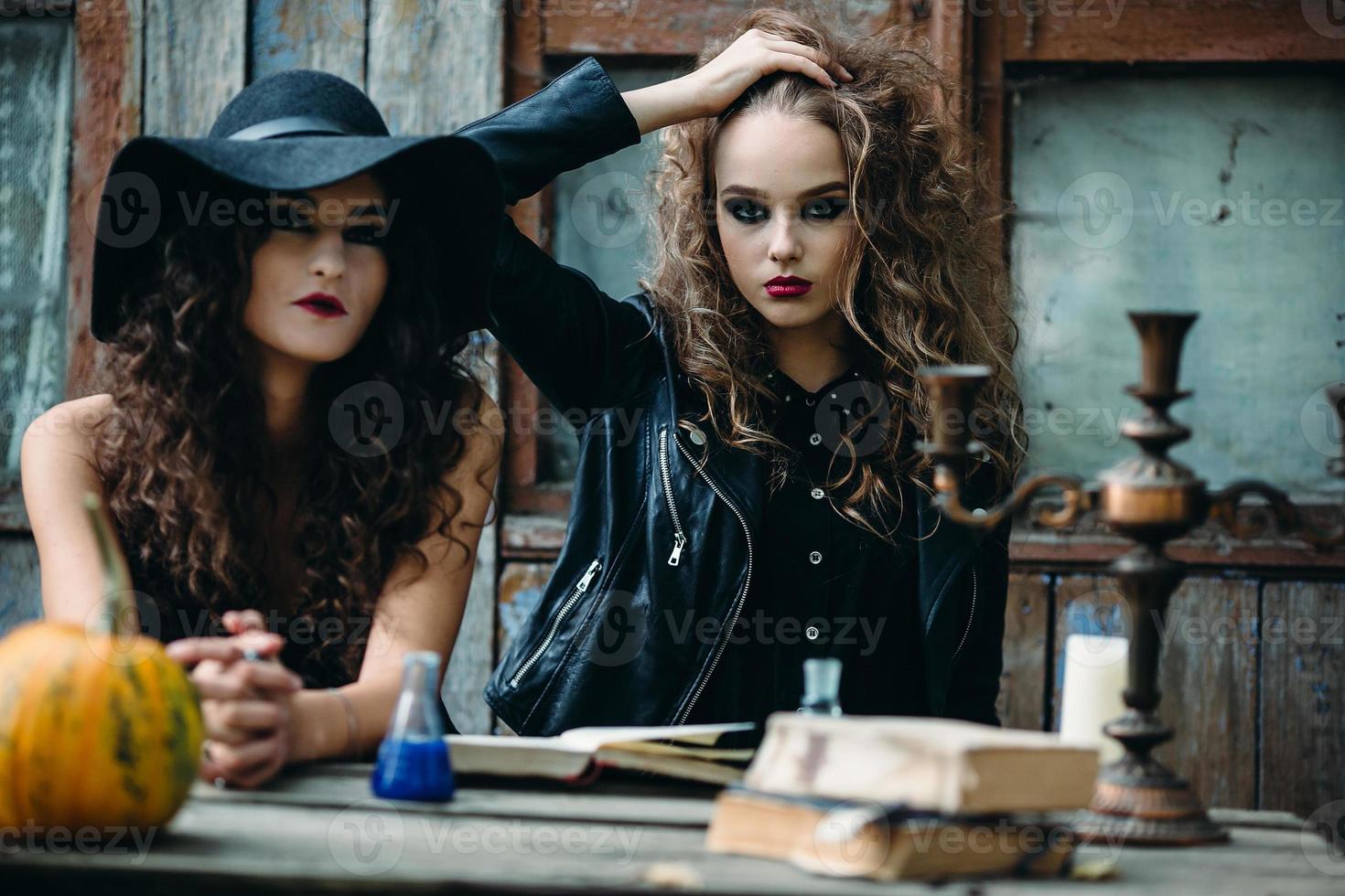 Two vintage witch sitting at the table photo