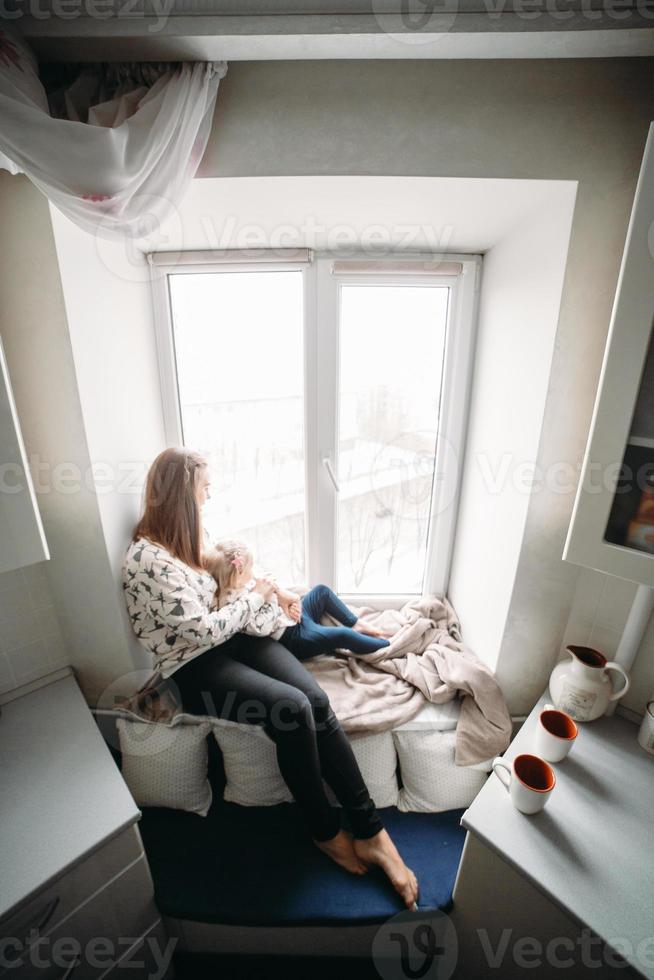 Mother and her daughter girl play in kids room photo