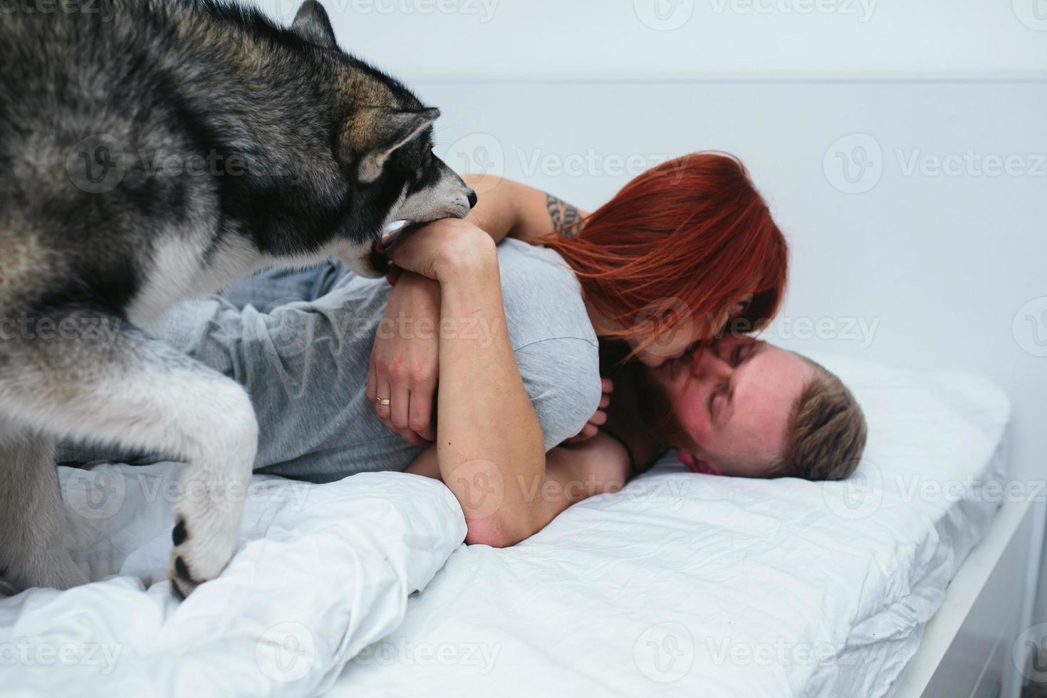 Young adult couple lying on bed photo