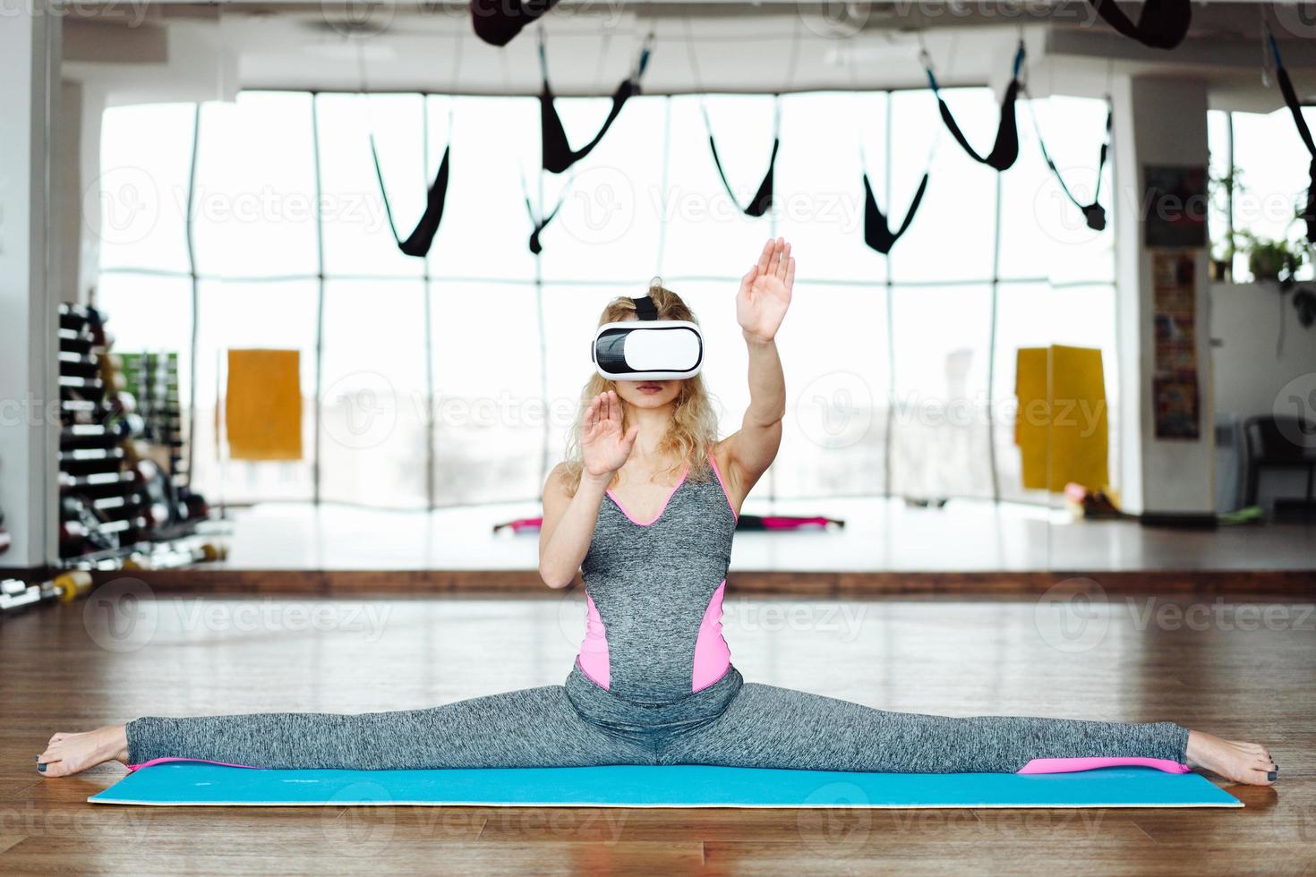 Woman in yoga class with VR headset photo