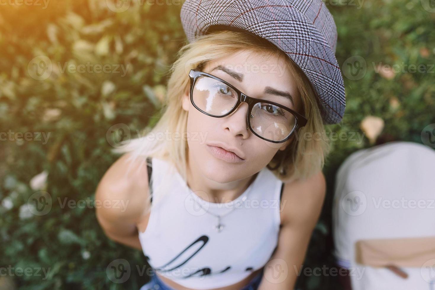 pretty girl sitting and looking at the camera photo