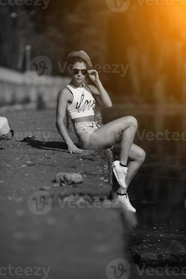 beautiful girl sitting on the pier photo