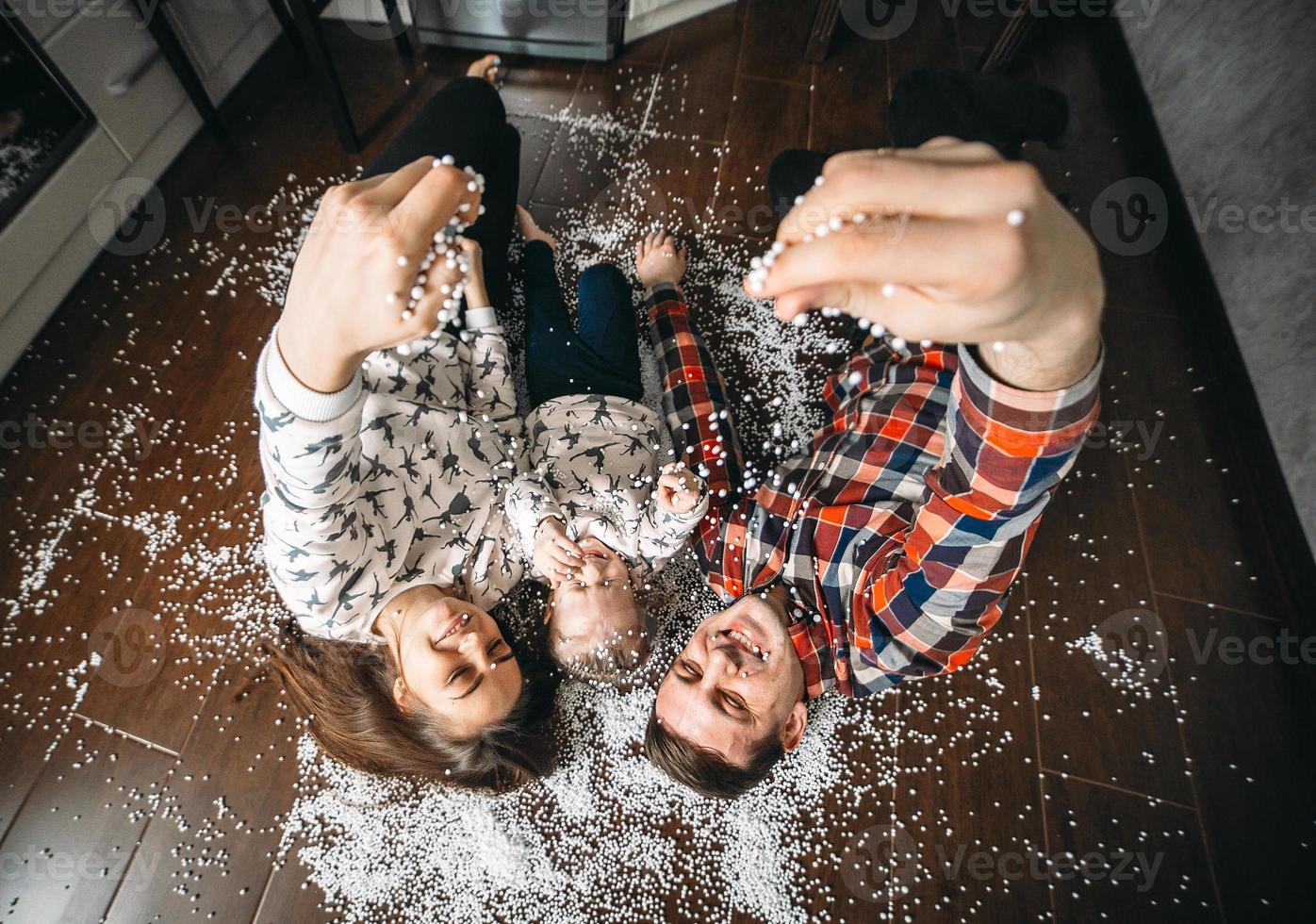 Happy family playing together on the floor photo