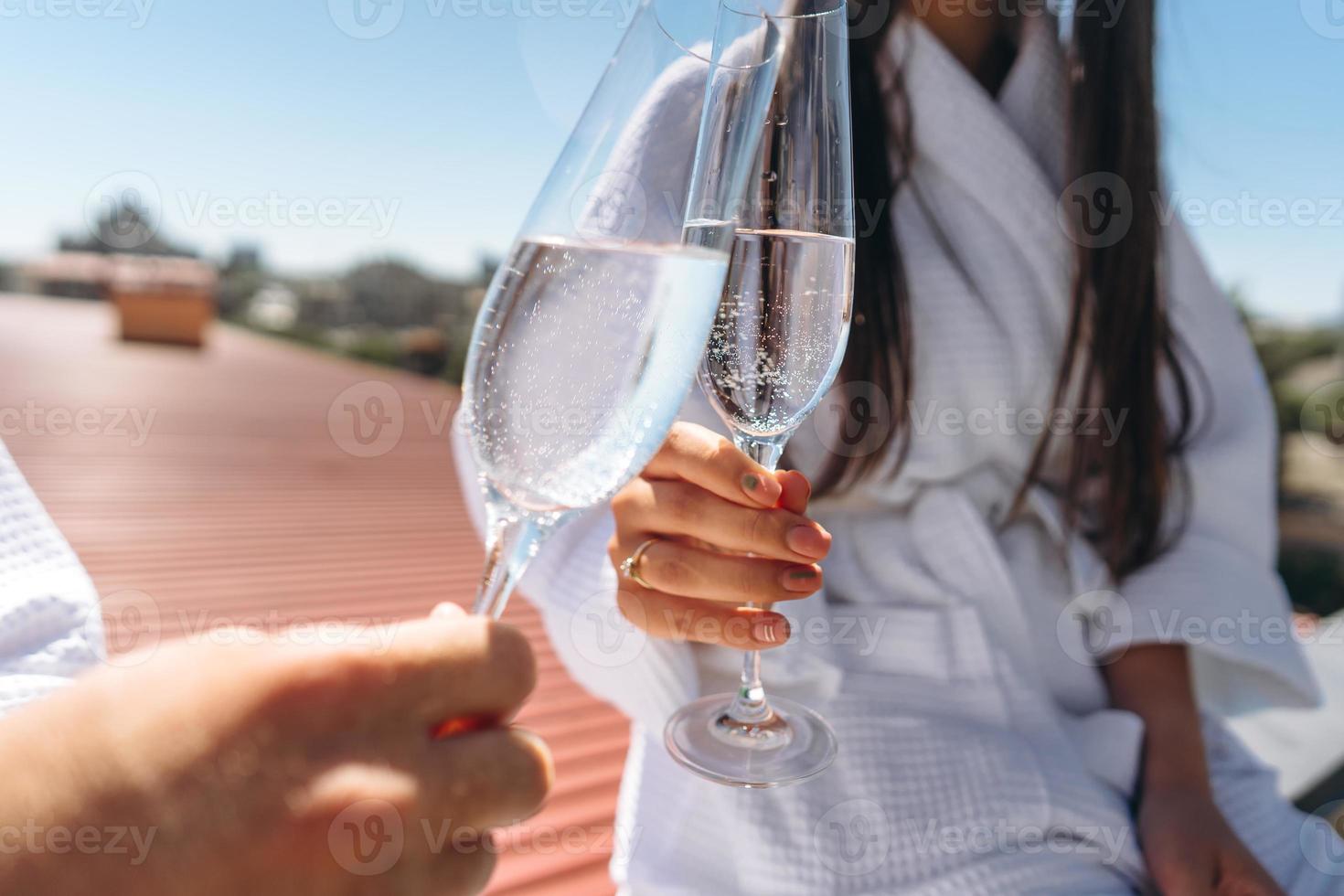 flirting couple with sparkling wine on a roof photo