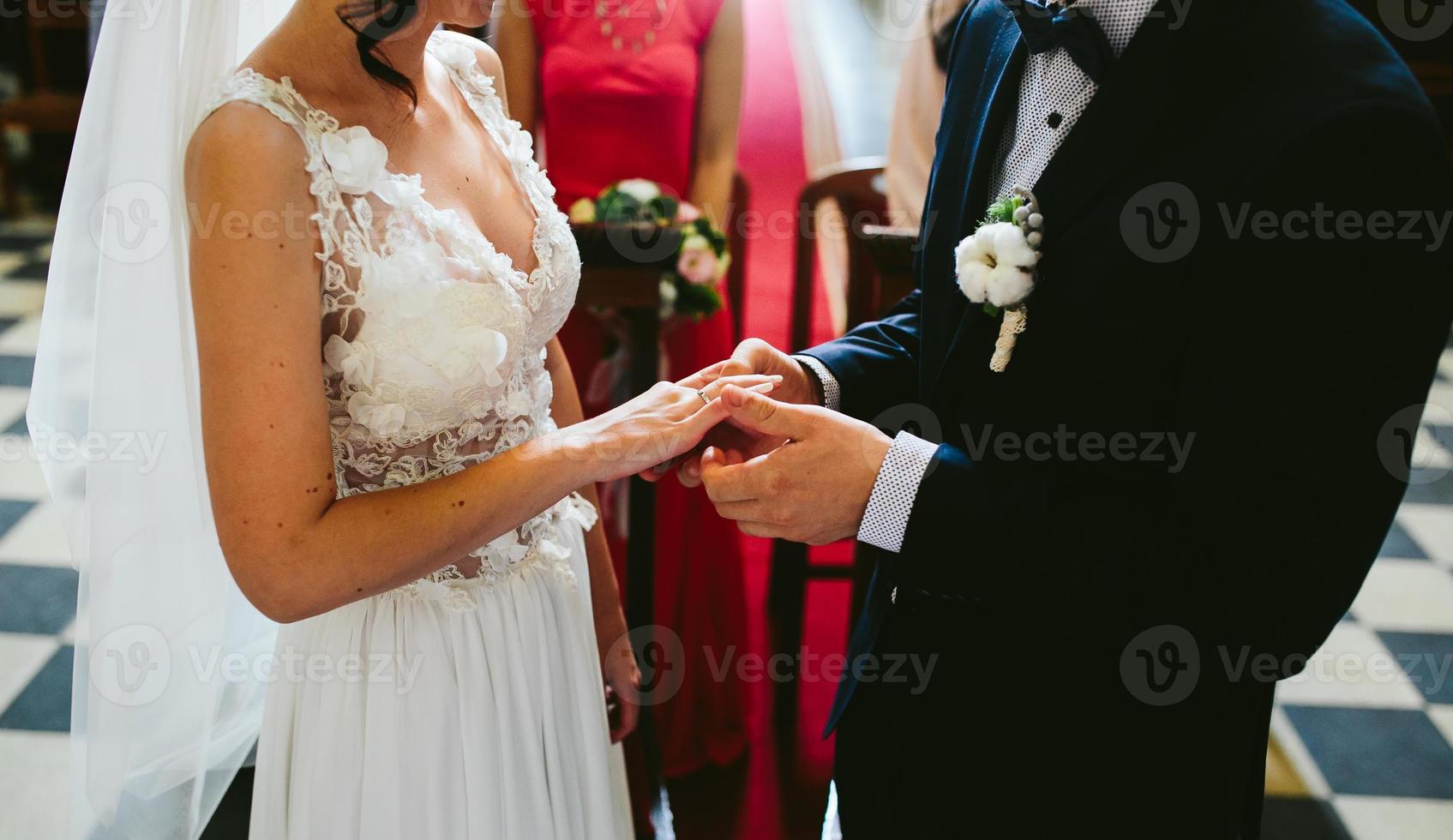 Putting the wedding ring on photo