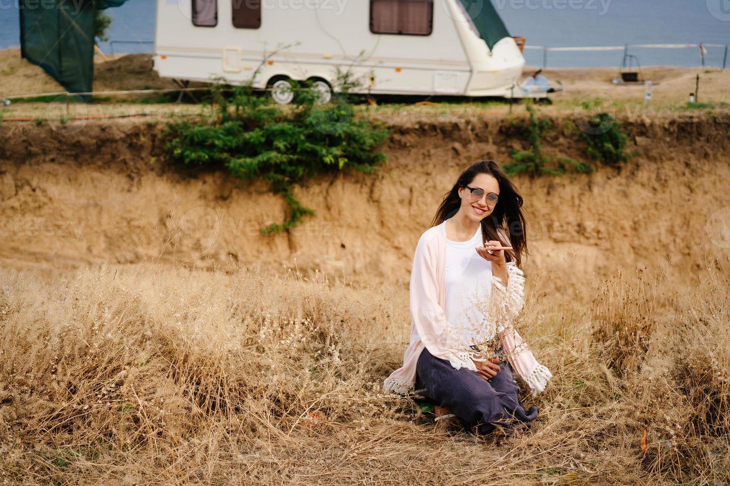 Beautiful, young girl posing on a wild seashore photo