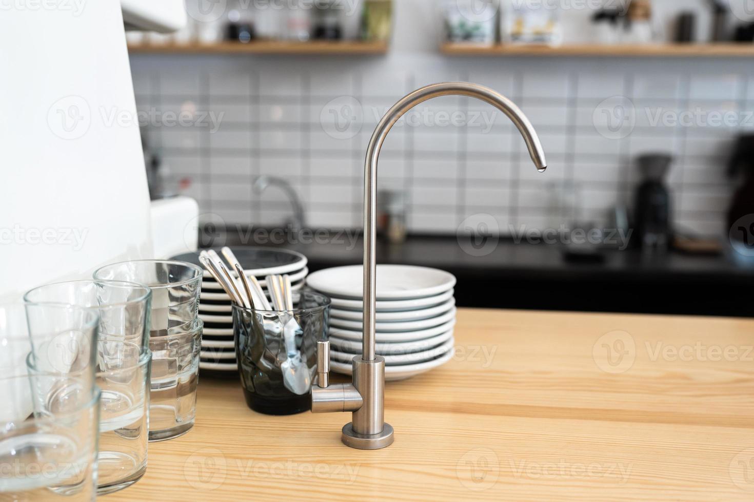 A kitchen countertop and a sink with dishes. photo