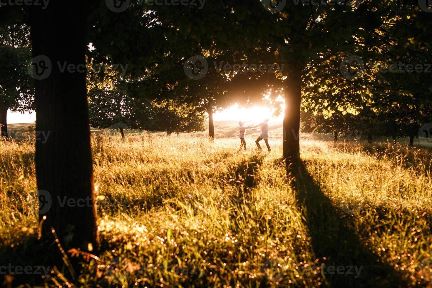 Couple running to the sunset photo