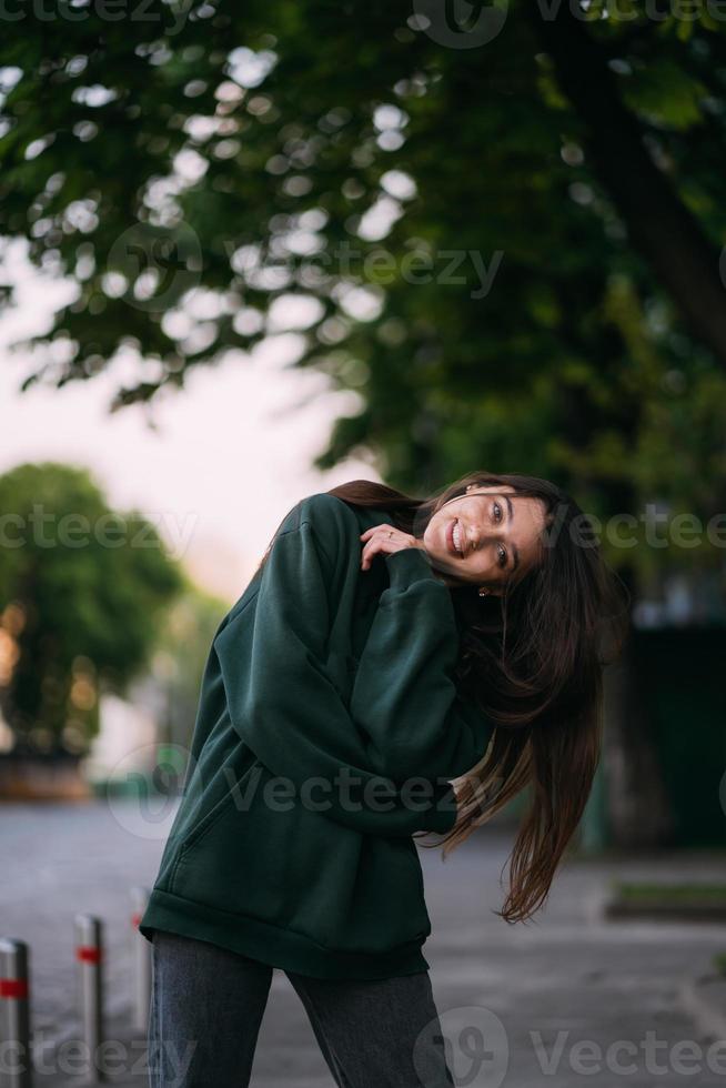 Portrait of cute girl with long hair looks at the camera photo