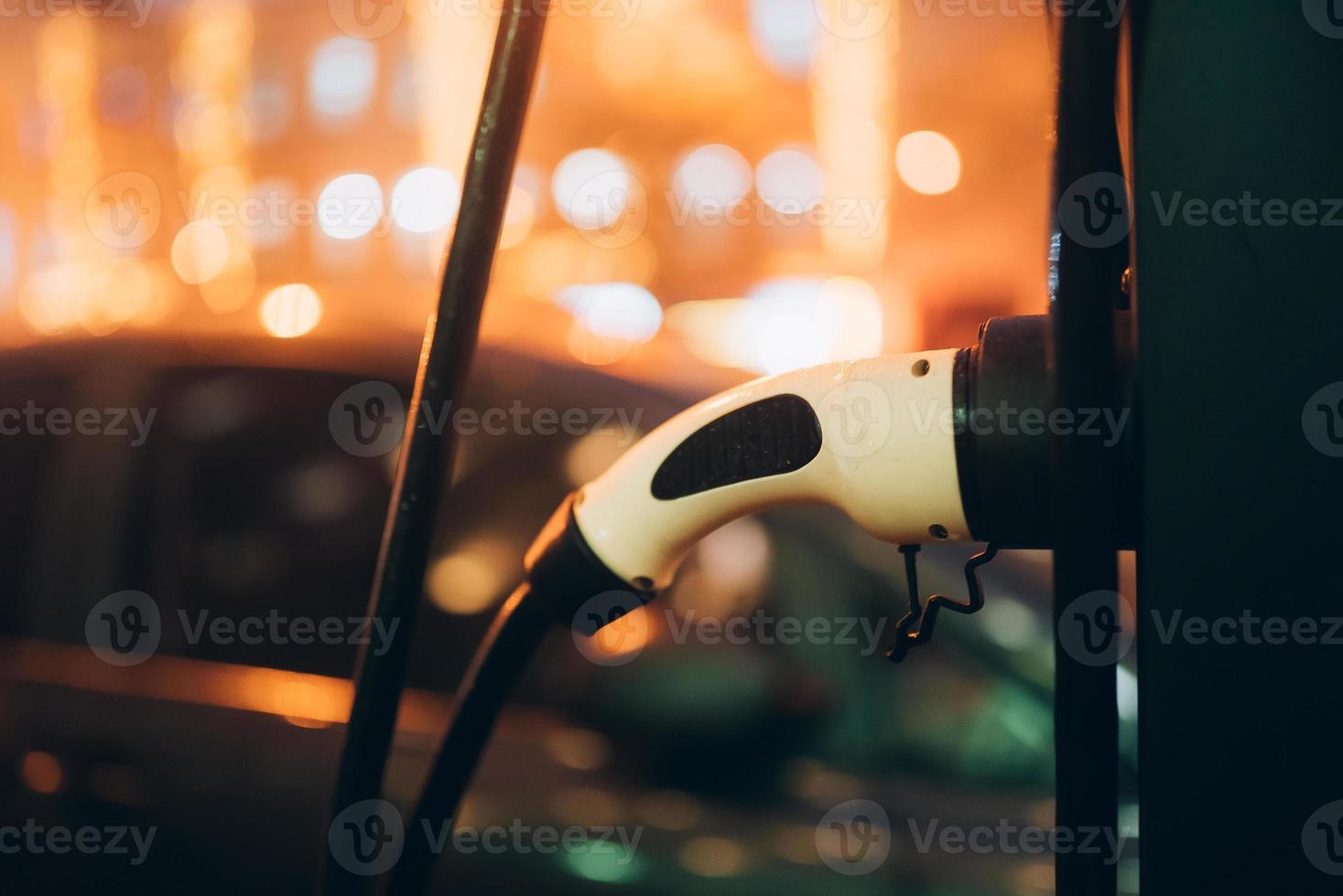 Electric car with power cable supply plugged in photo