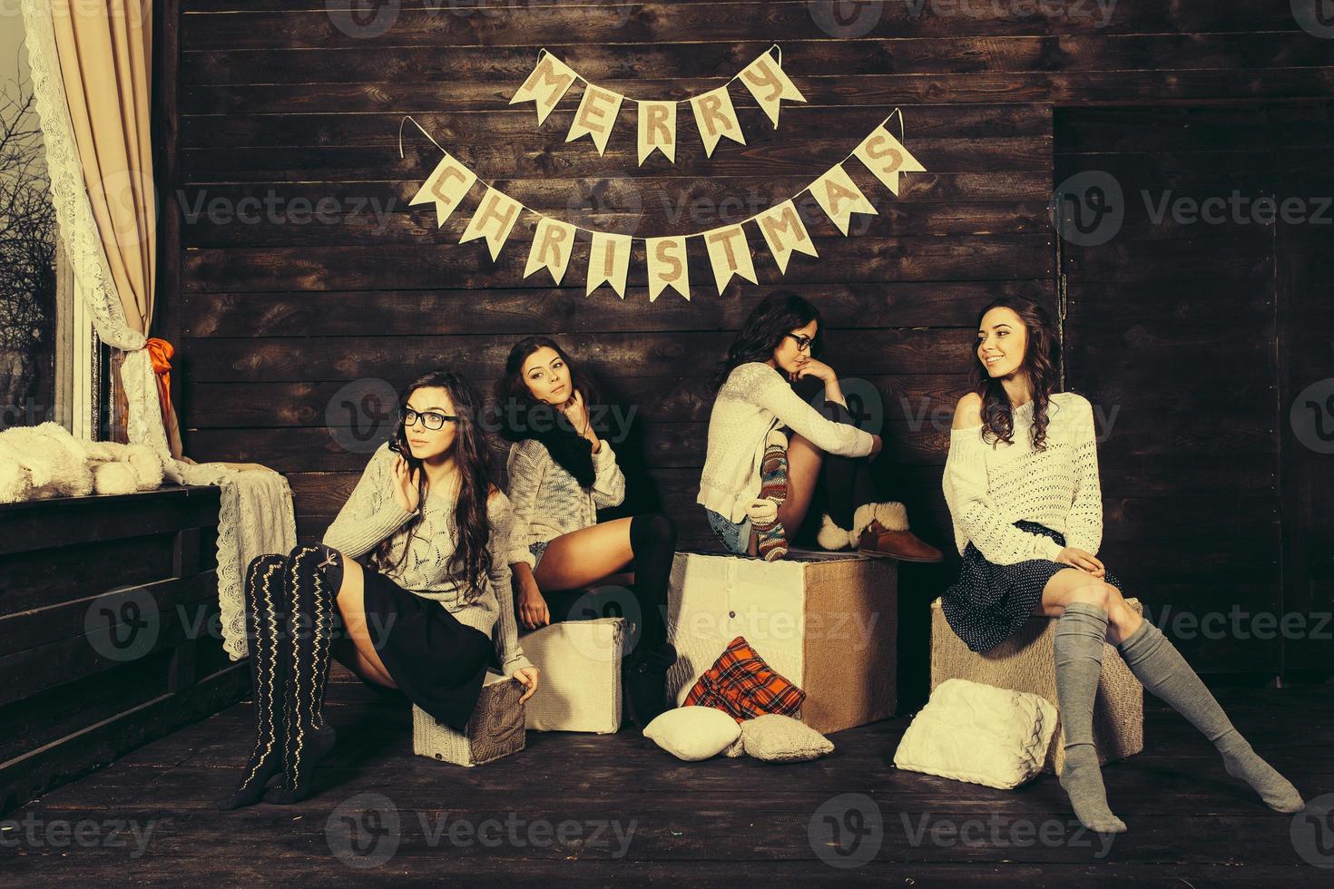 Four charming model posing on a vintage New Year's background photo