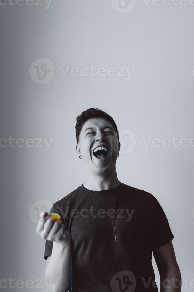 The guy holds a crushed egg and laughs photo