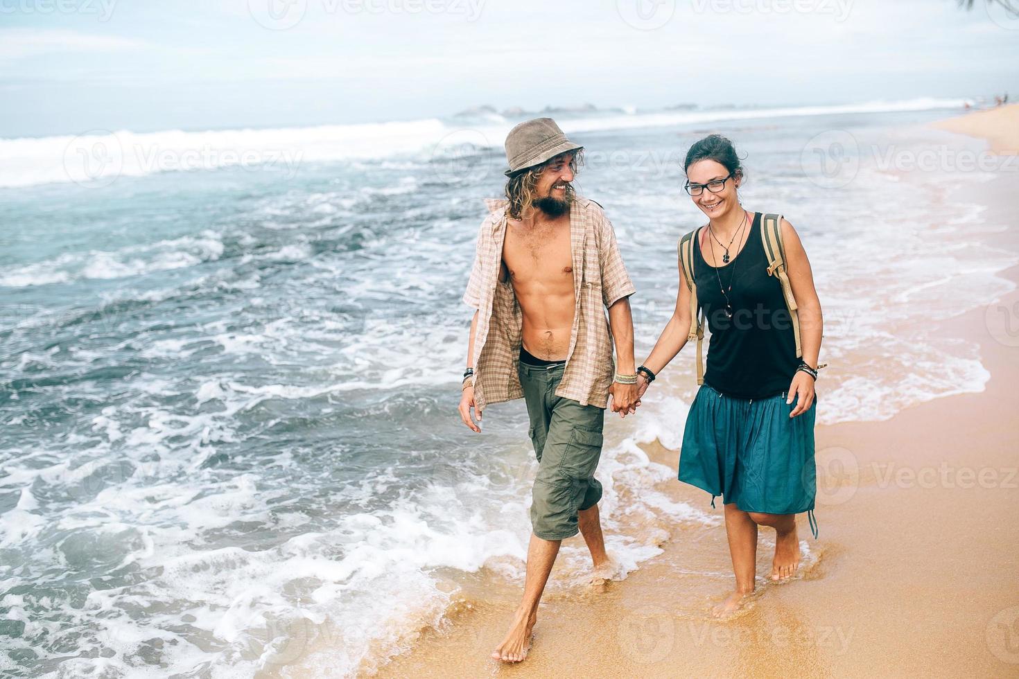 a guy and a girl are walking along photo