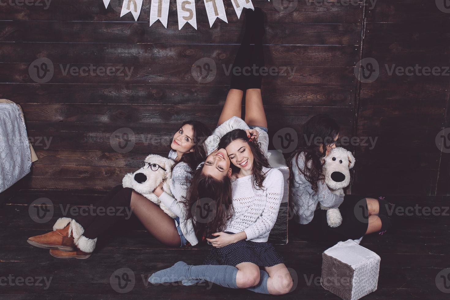 Four charming model posing on a vintage New Year's background photo