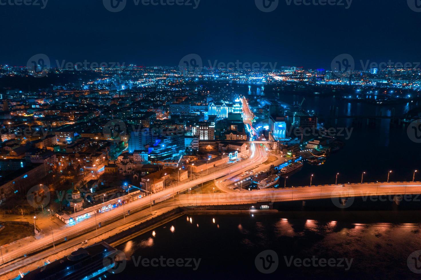 Highway at night in modern city. Aerial view of cityscape photo