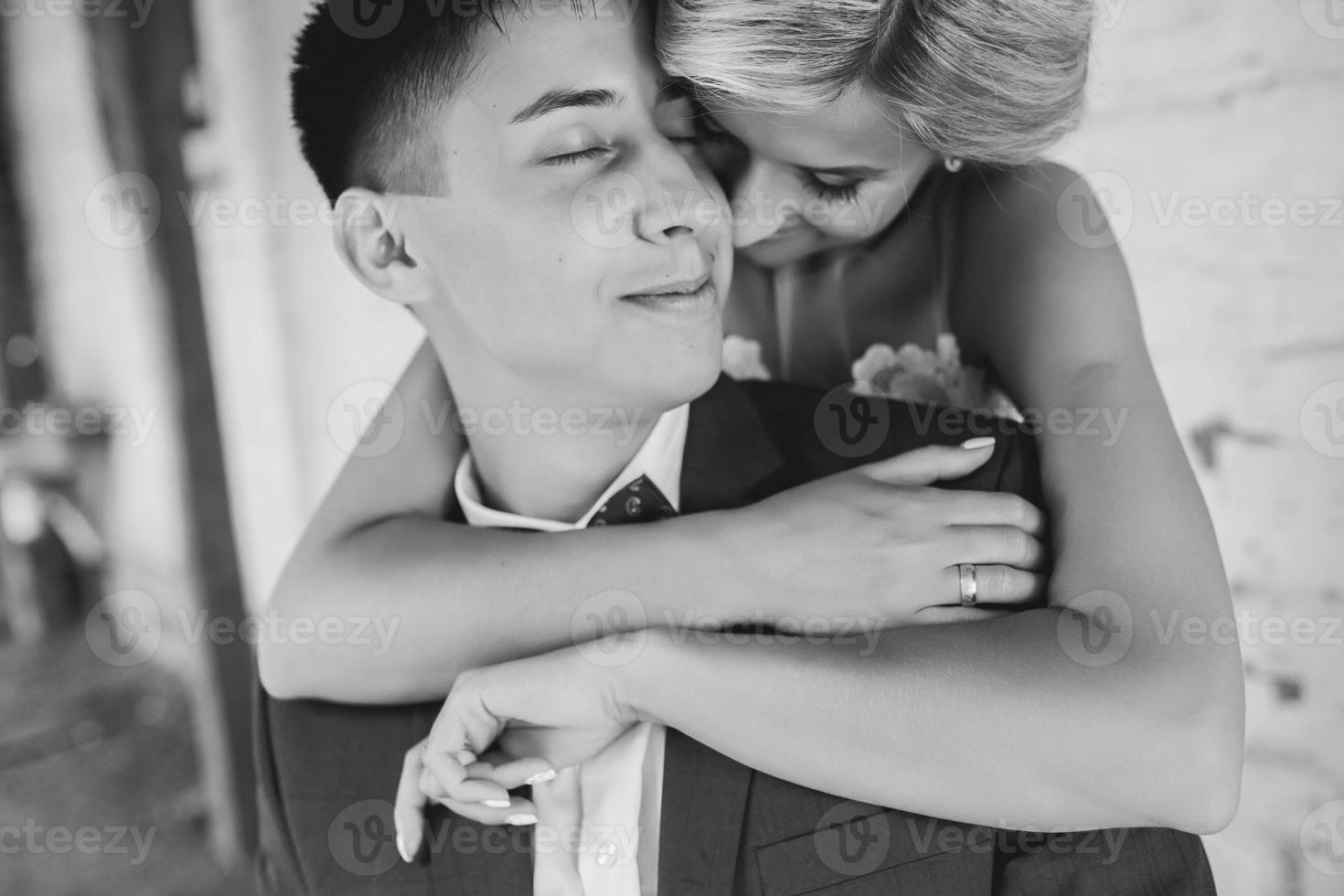 Bride embraces bridegroom photo