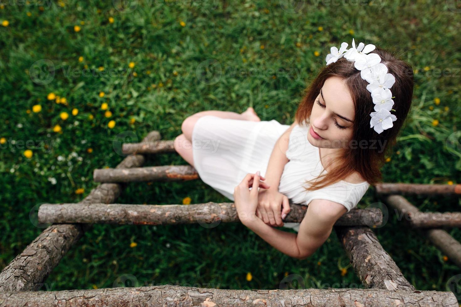 Lovely girl near a wooden house photo