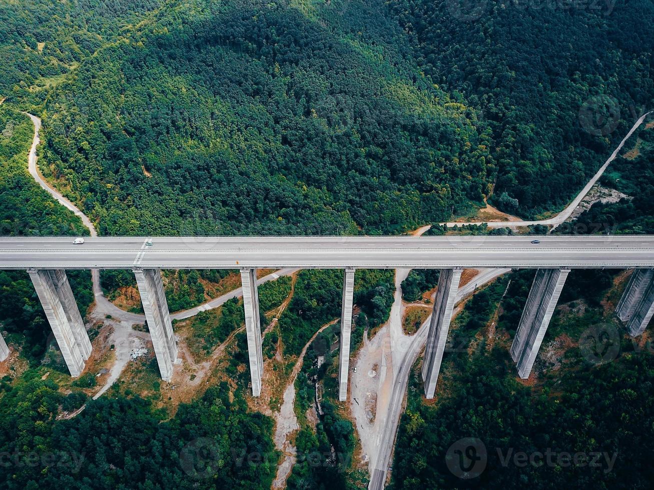 Aerial view of the road in the mountains over the bridge photo