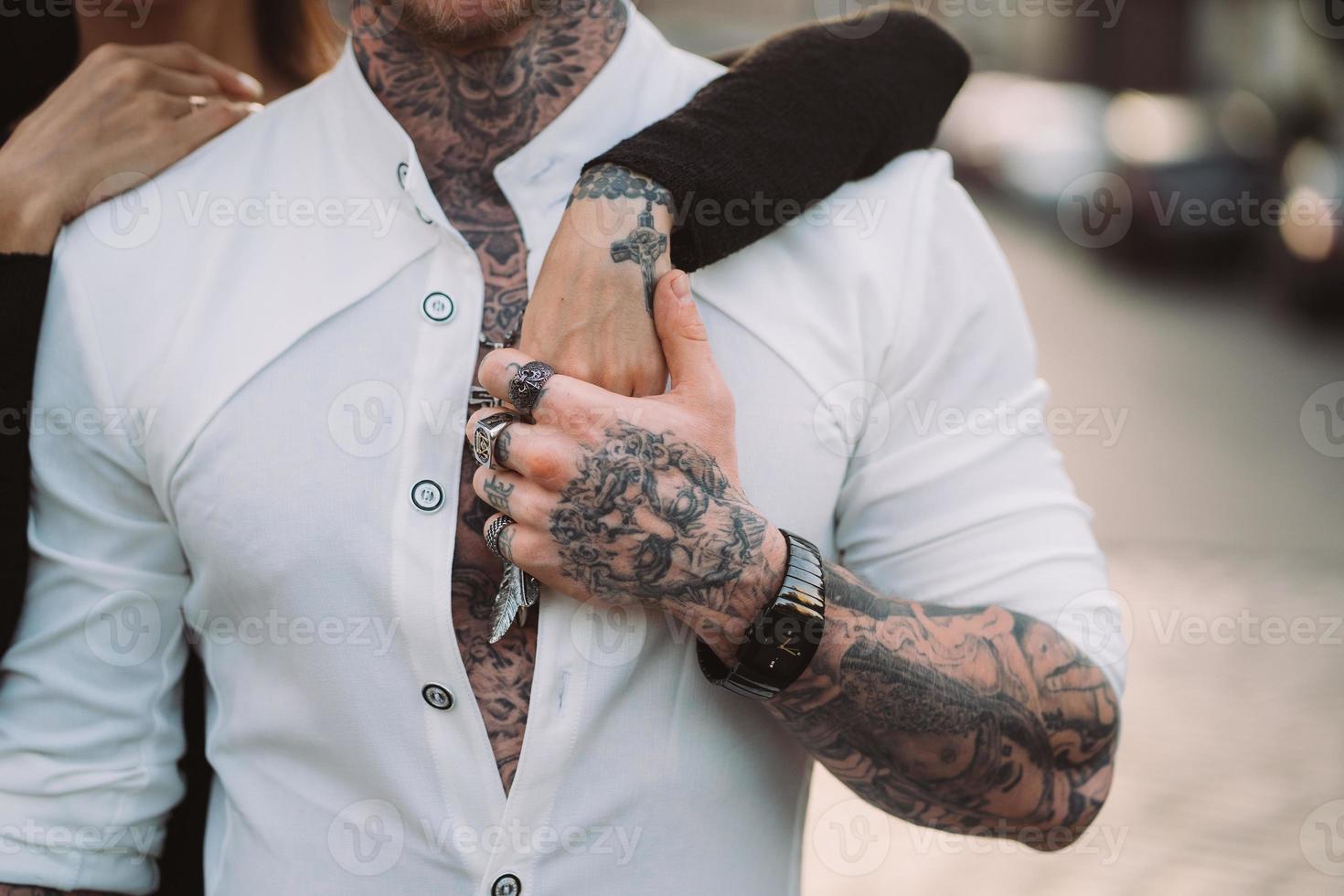 A man holds a woman's hand on his torso photo