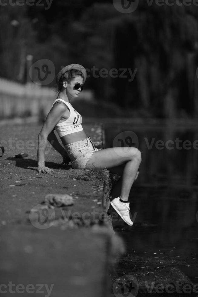 beautiful girl sitting on the pier photo