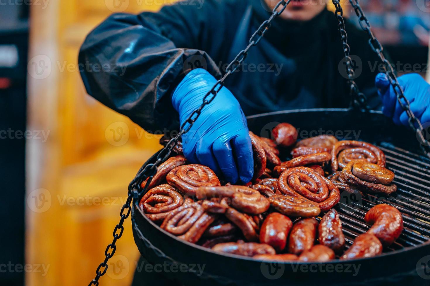 Two tier grill with delicious spiral sausages photo