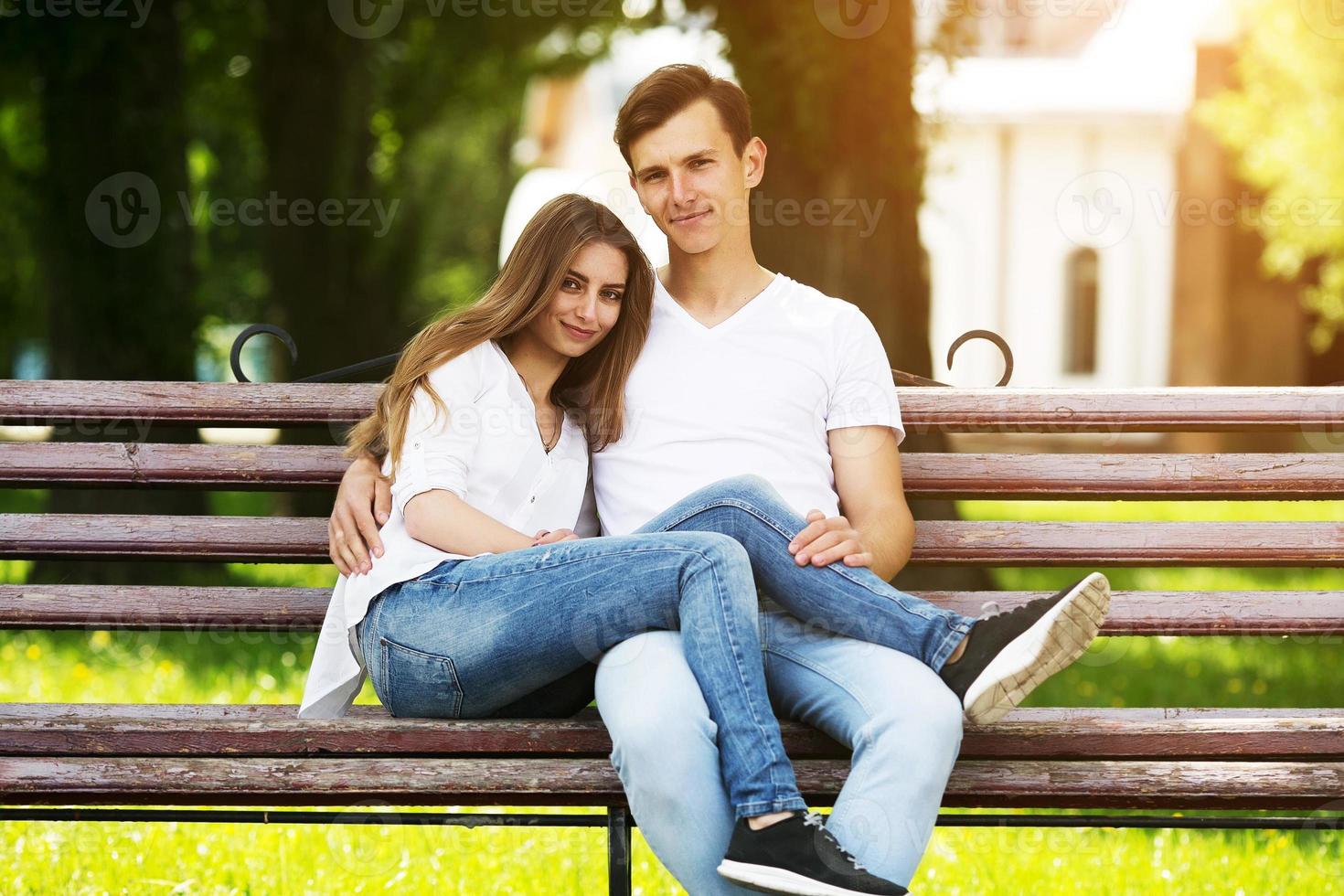 man and woman on a bench in the park photo