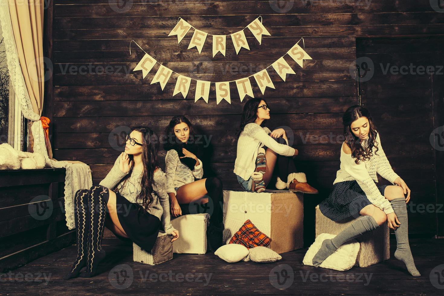Four charming model posing on a vintage New Year's background photo