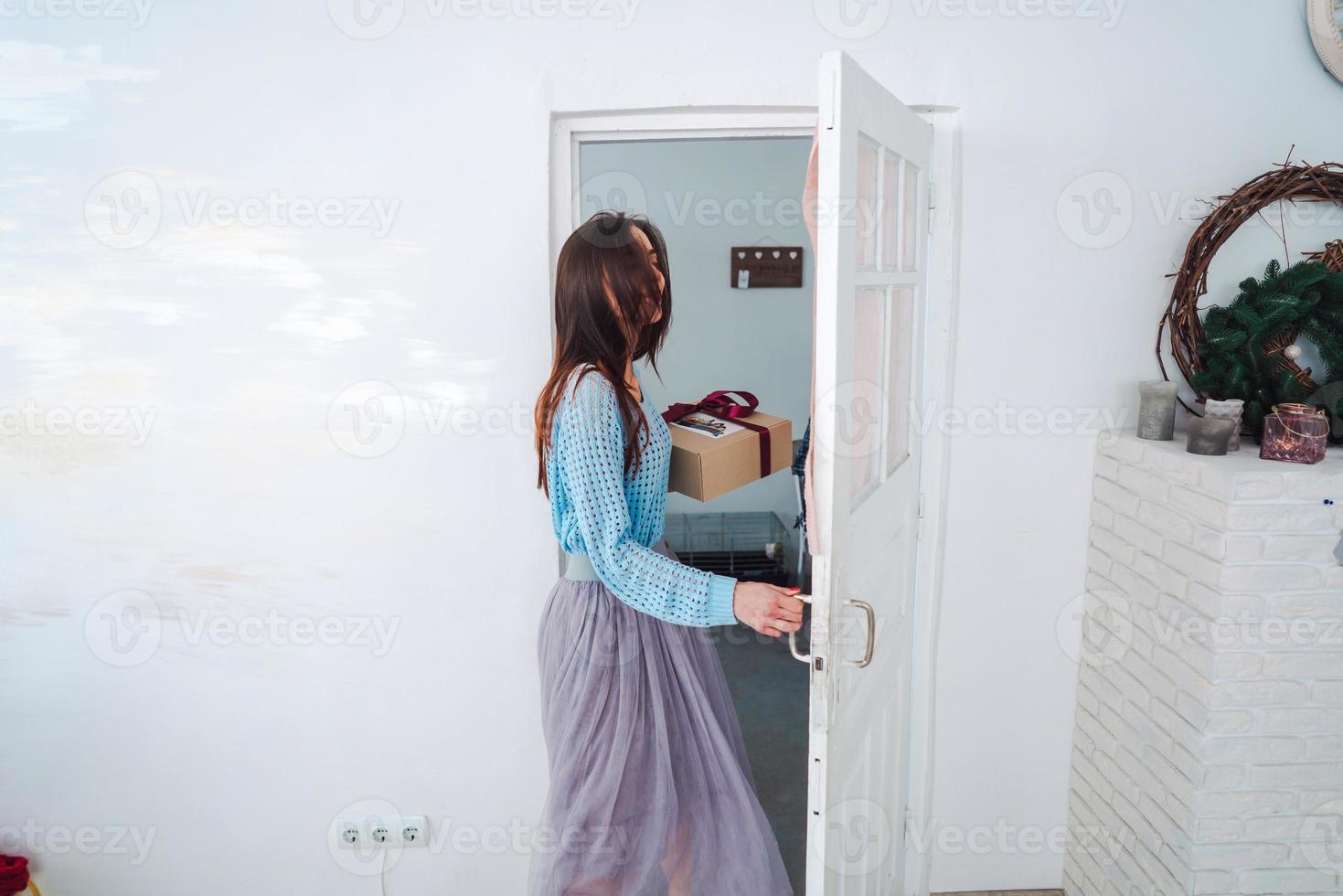 Woman holding Christmas gift box in her hands photo