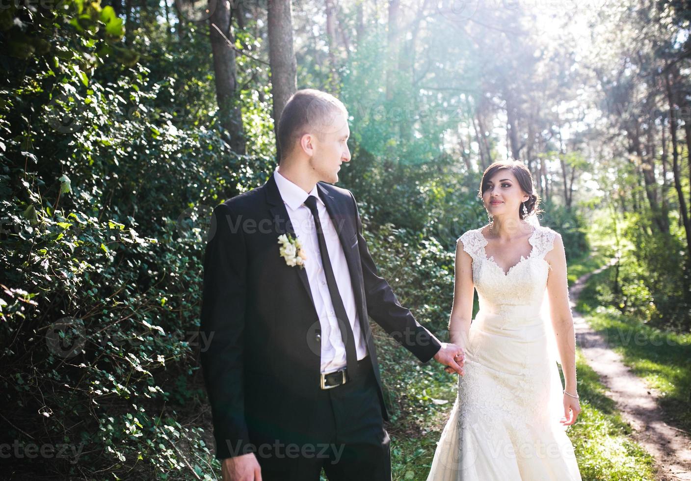 Charming bride follows the groom photo