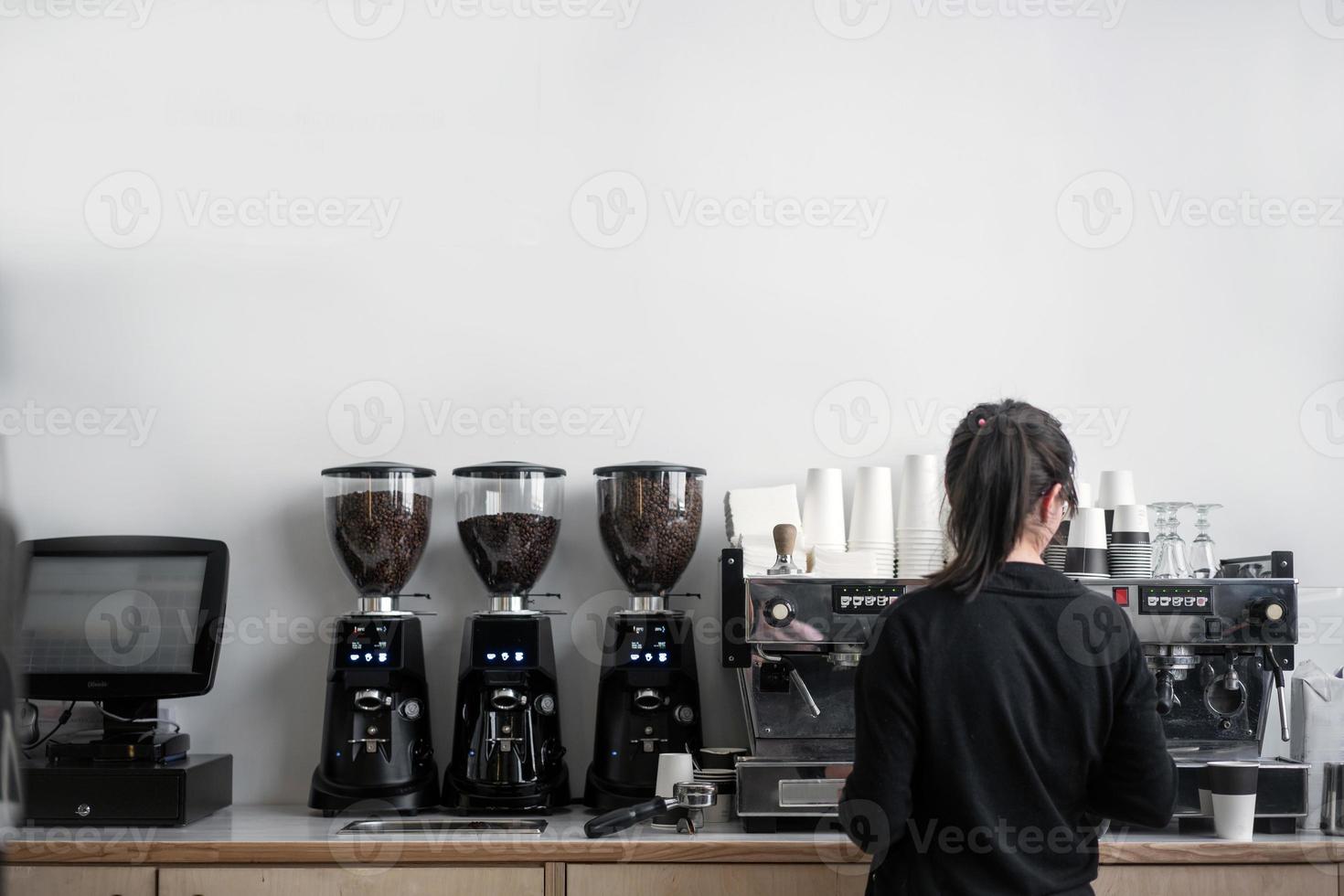 Female barista makes coffee photo