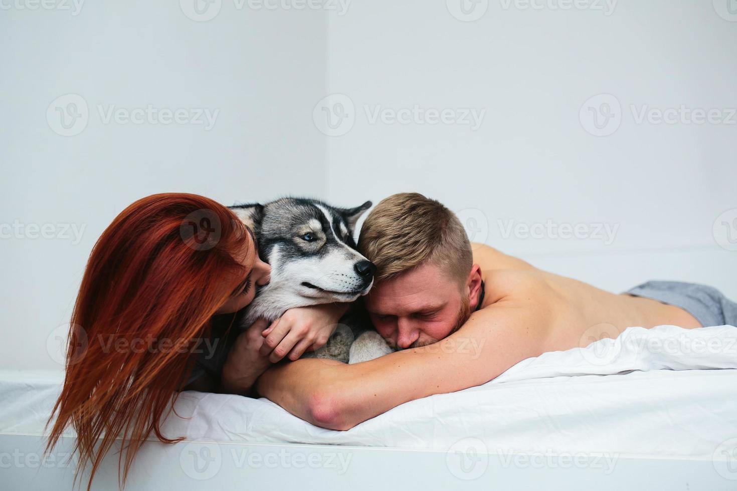 Young adult couple lying on bed photo