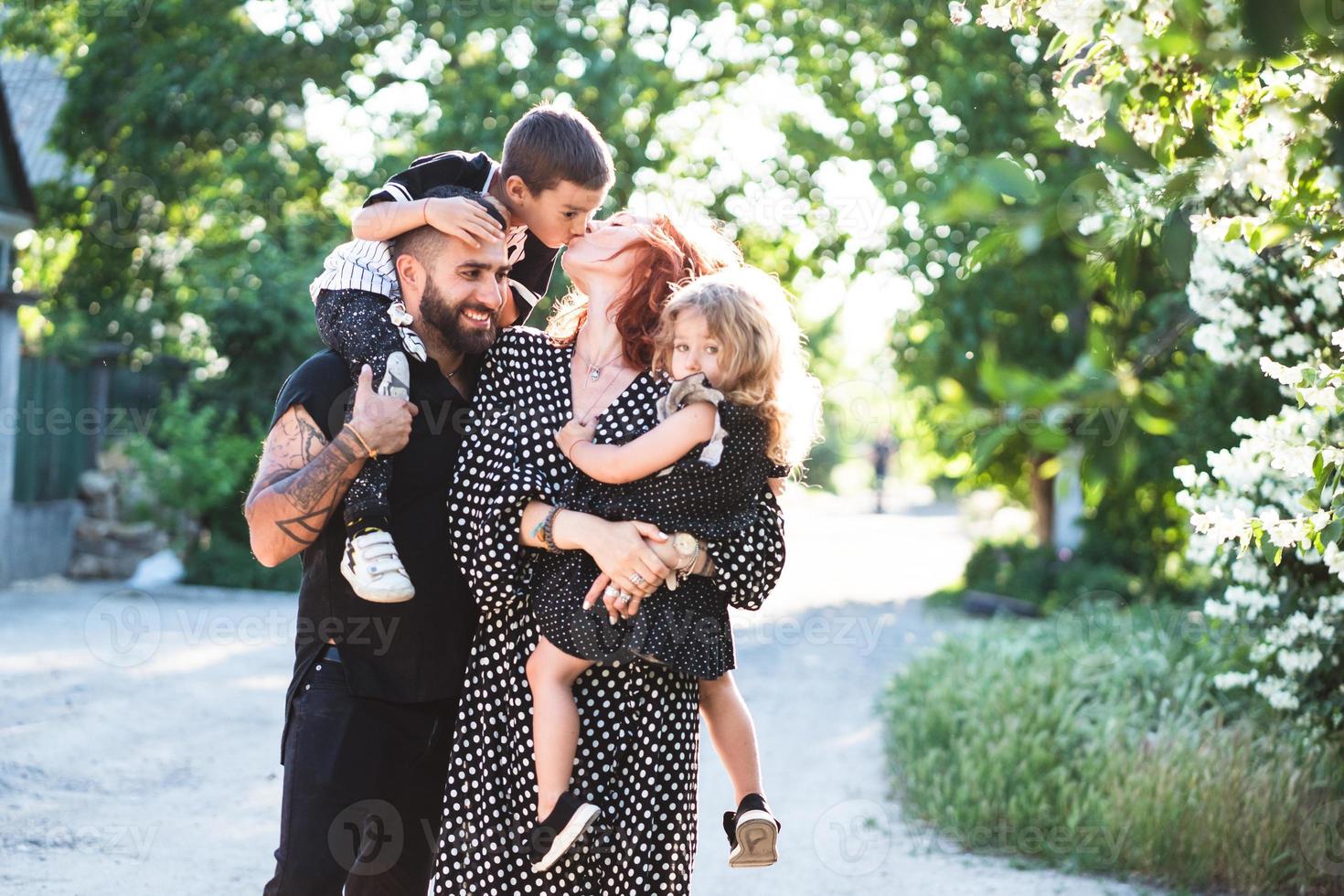 Mom, Dad, little son and daughter have fun photo