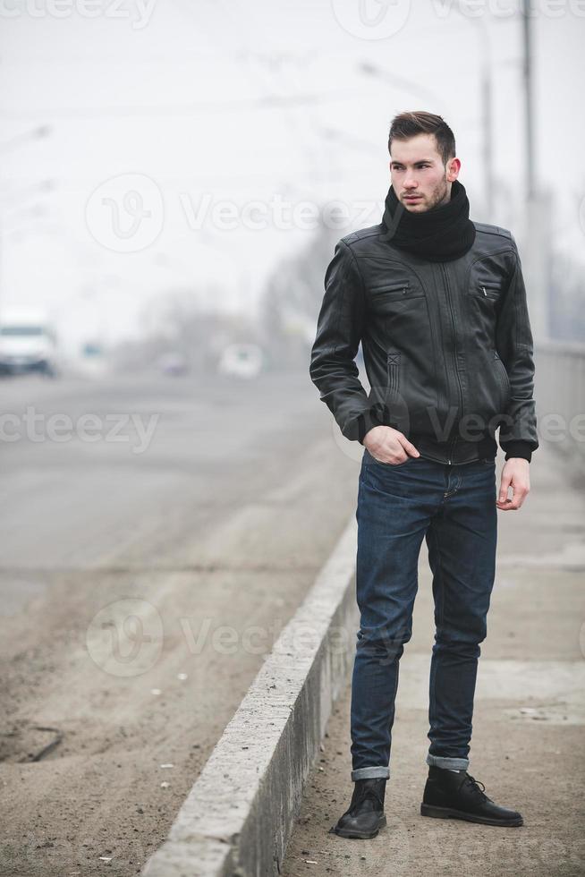 Man in jeans and black jacket photo