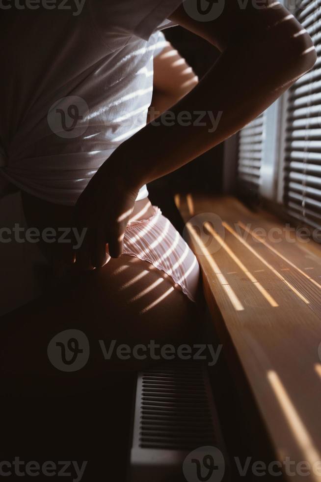 Young woman near the window in the morning photo