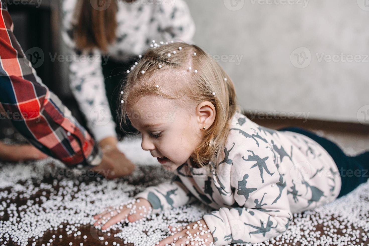 Little girl is playing with foam balls photo