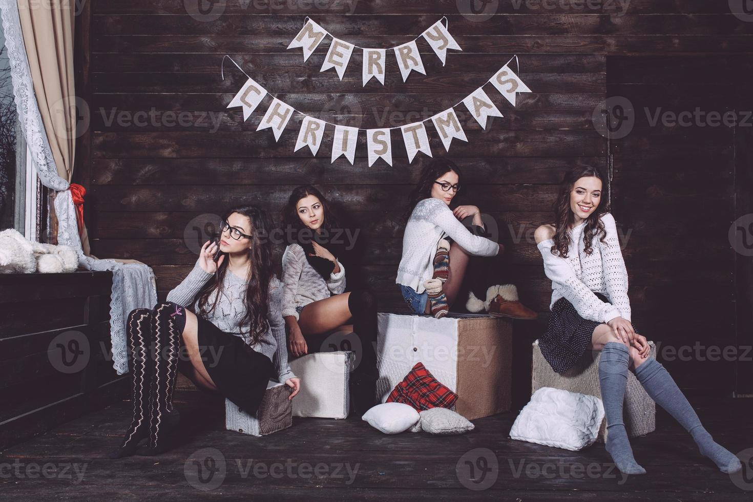 Four charming model posing on a vintage New Year's background photo