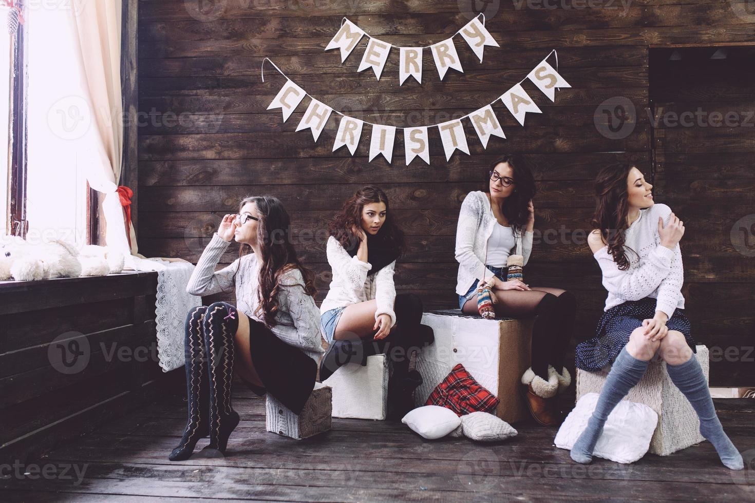 Four charming model posing on a vintage New Year's background photo