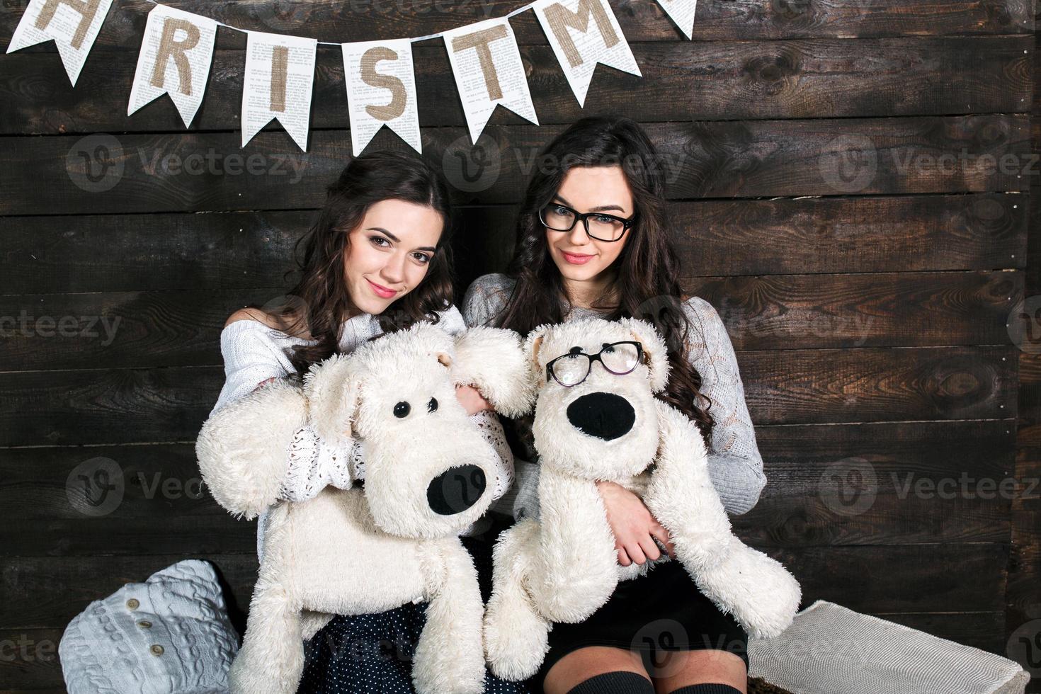 Two charming girls playing with Christmas toys photo