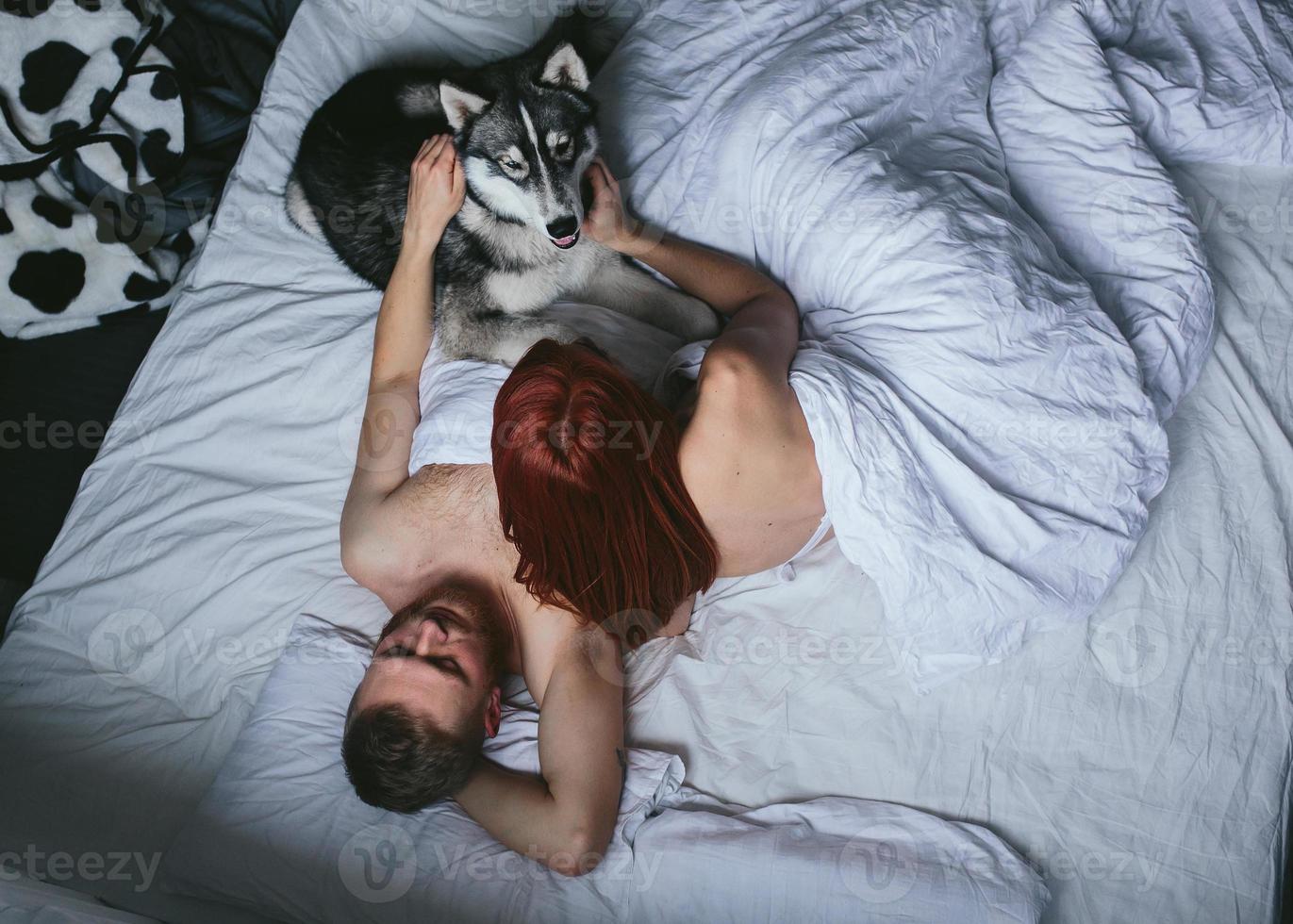 Young adult couple lying on bed photo