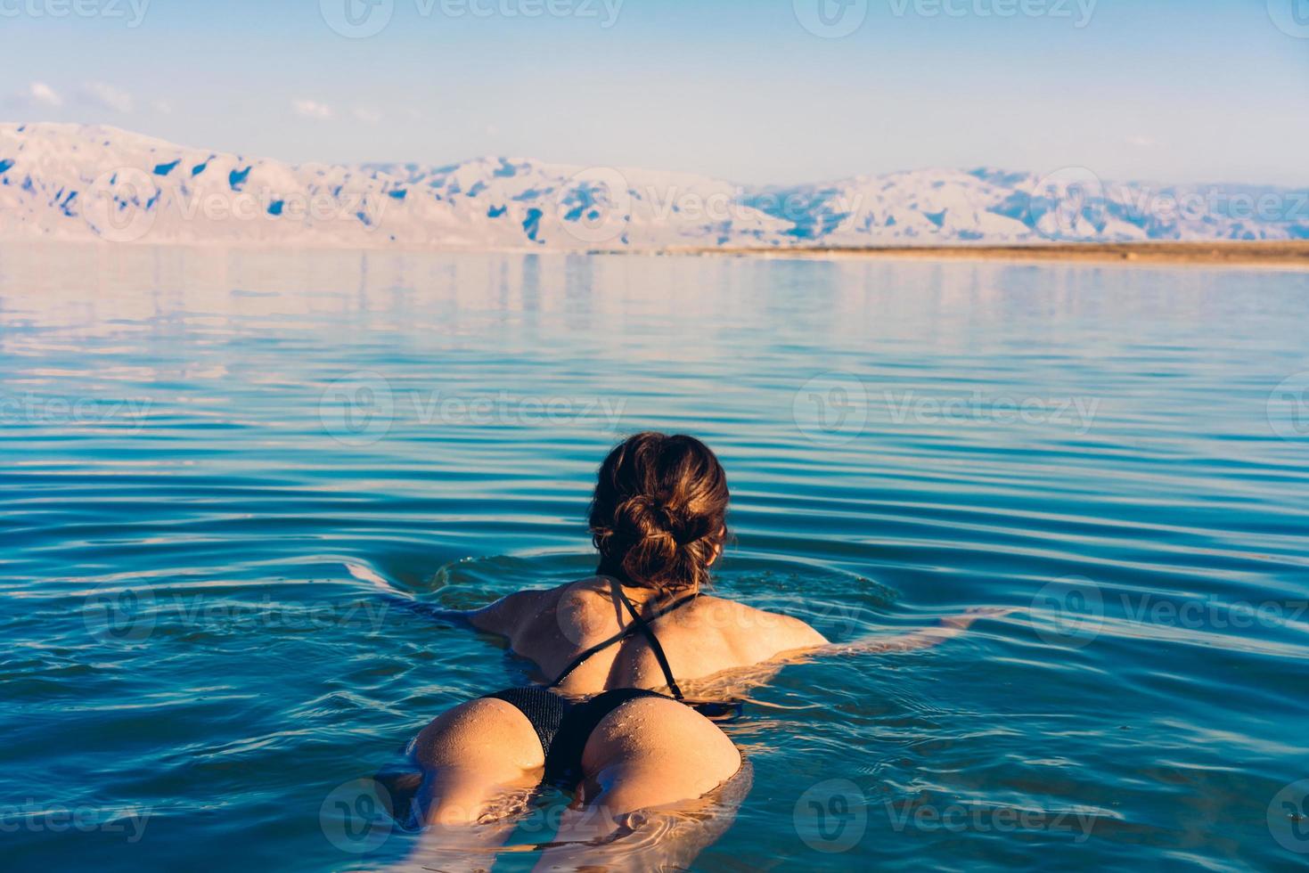 Girl is relaxing and swimming in the water photo