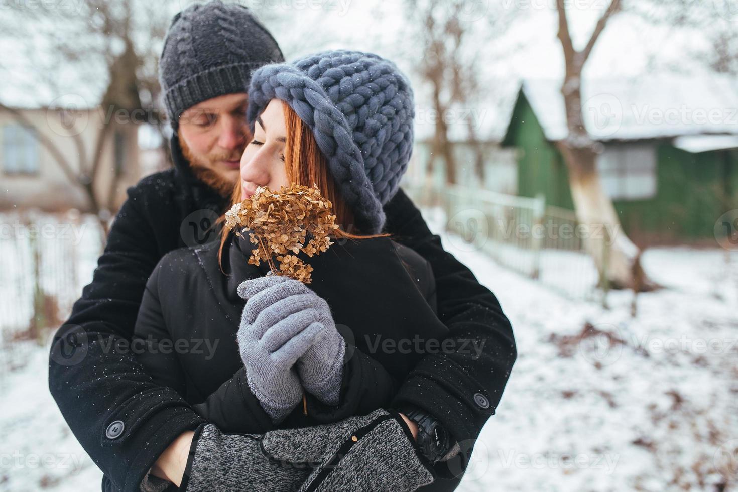 man hugging his girlfriend on the street photo