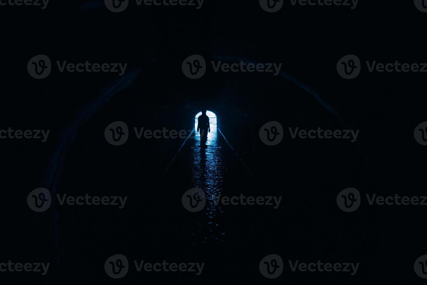 Silhouette of a woman in a tunnel photo